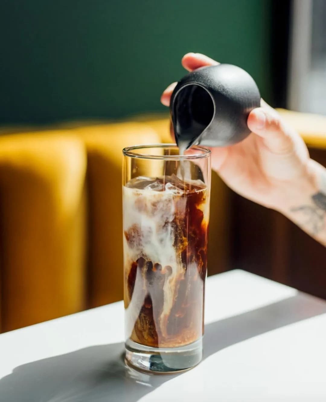 Iced coffee poured over ice